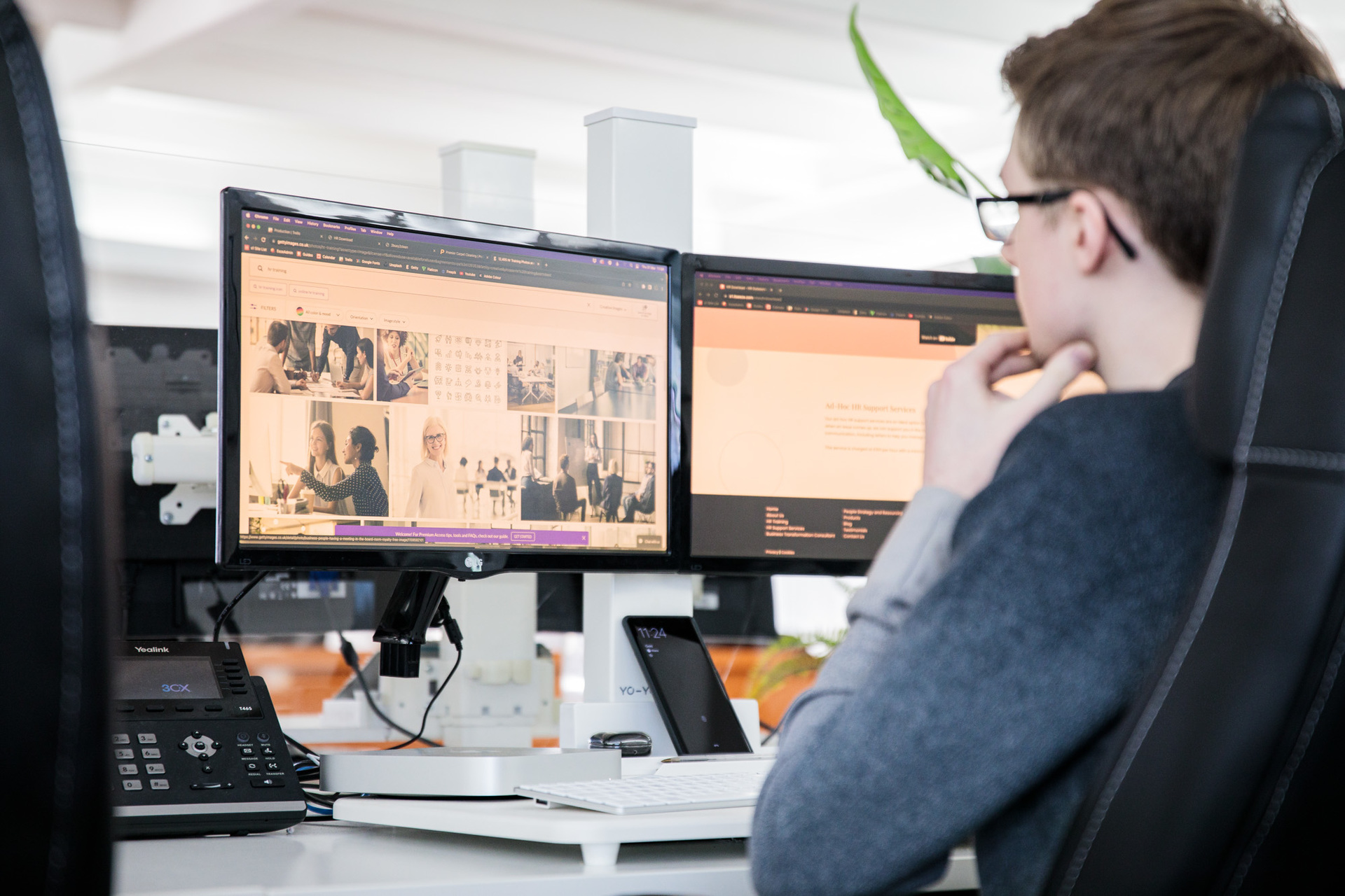 A website designer looking at his desktop computer screen