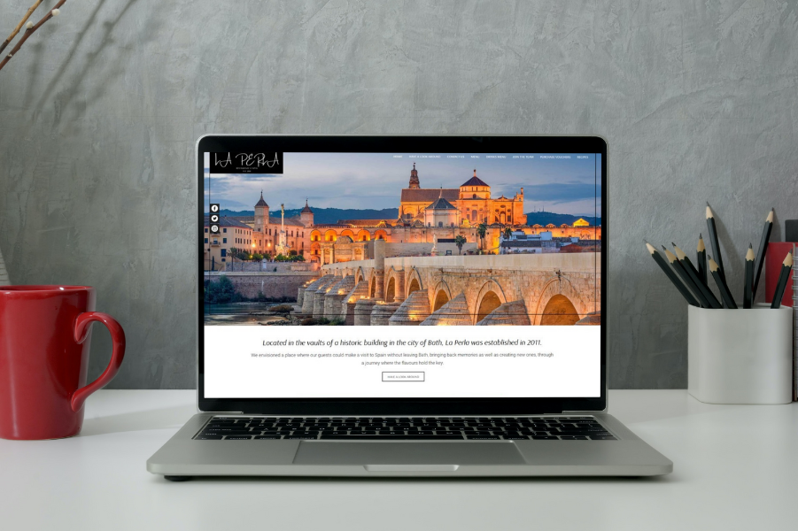 A website design to show off a Spanish restaurant shown on a laptop.