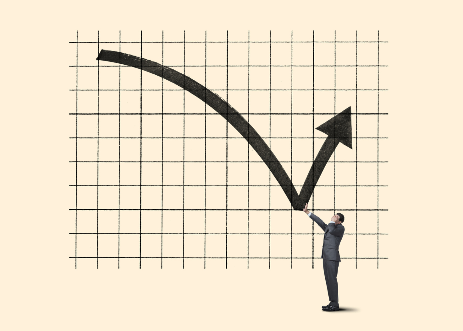 A man stood next to a graph showing an arrow steadily going down and then suddenly goes up.