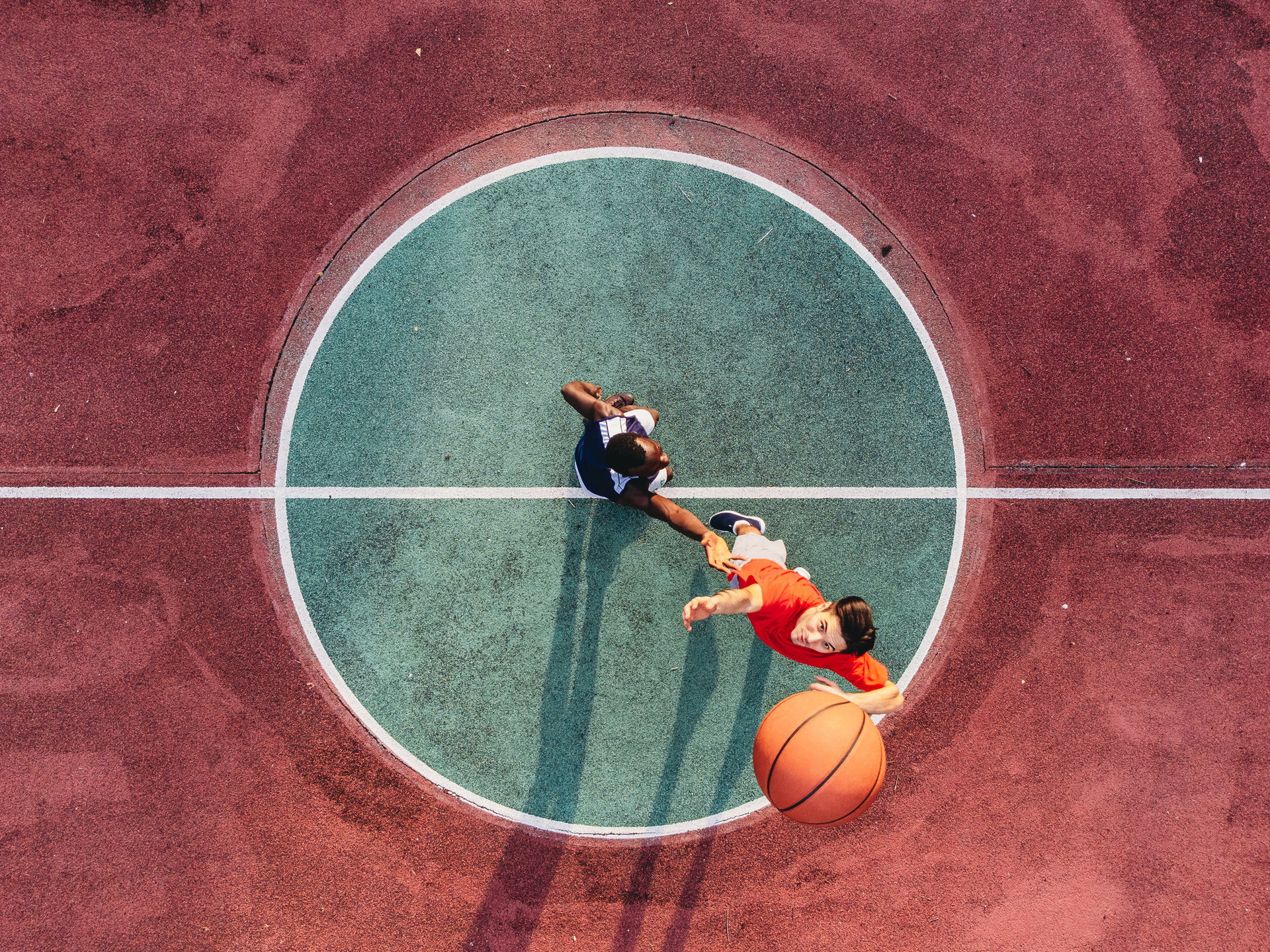 A basketball court with two people playing