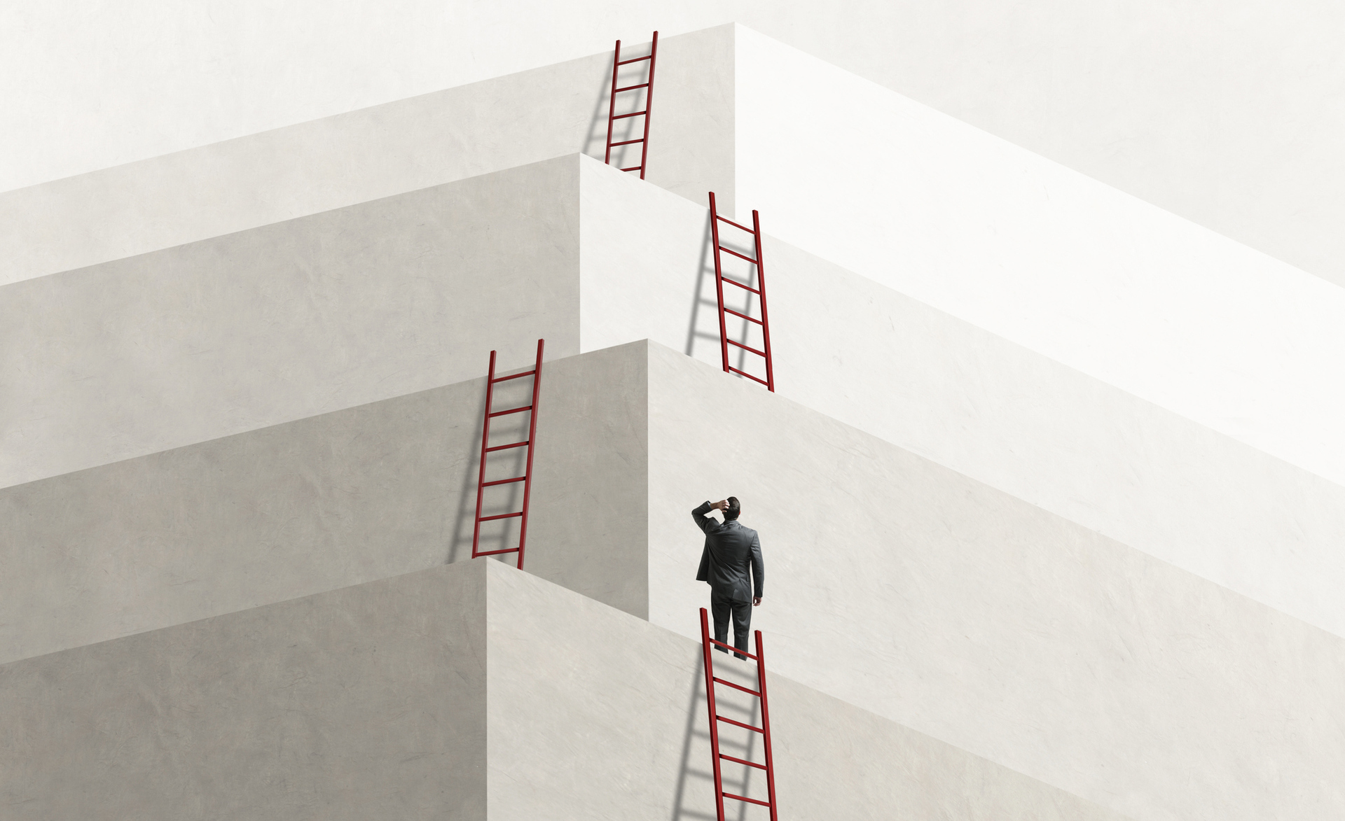 A person stood at the bottom level evaluating the next steps to the nearest ladder