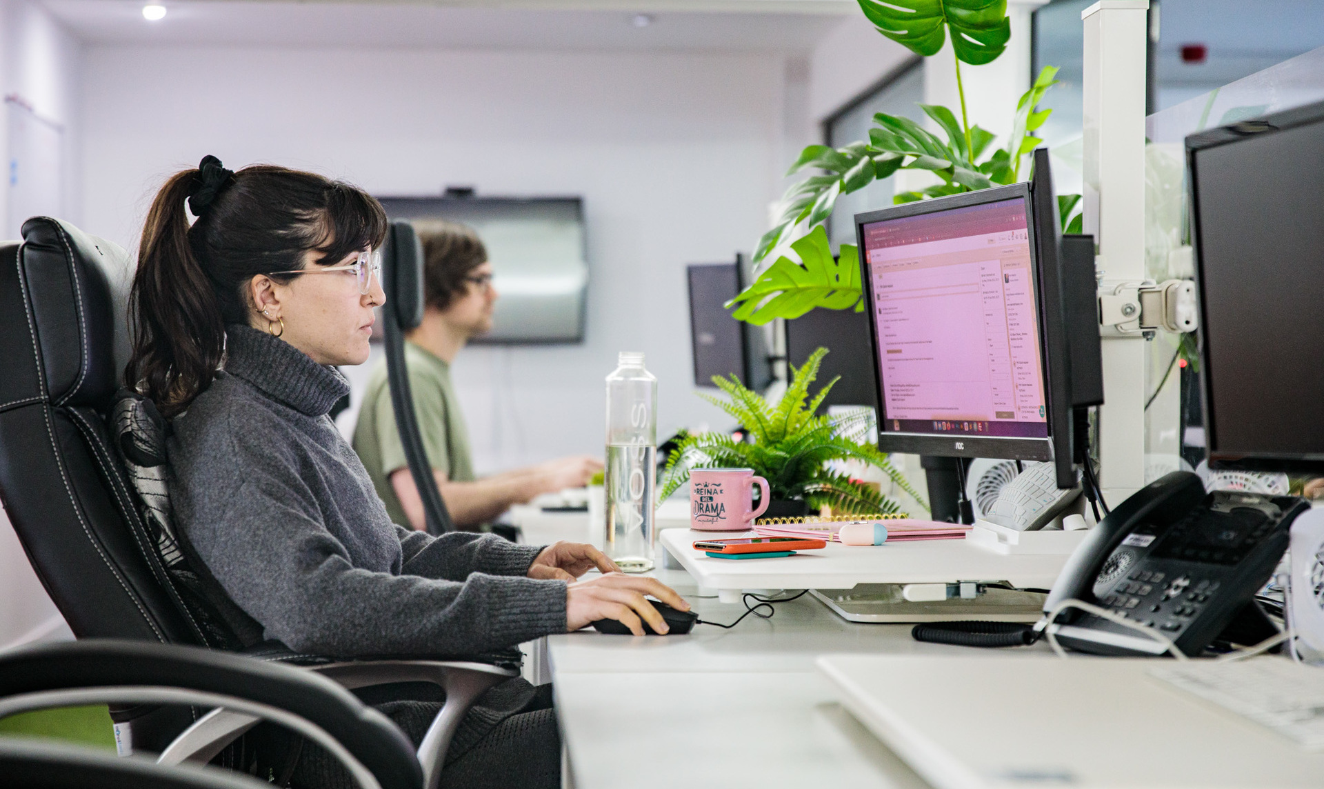 A web designer sat at her desk working on her computer
