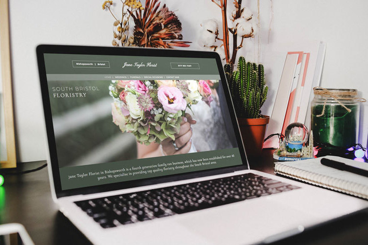 A floristry website design shown on a laptop.